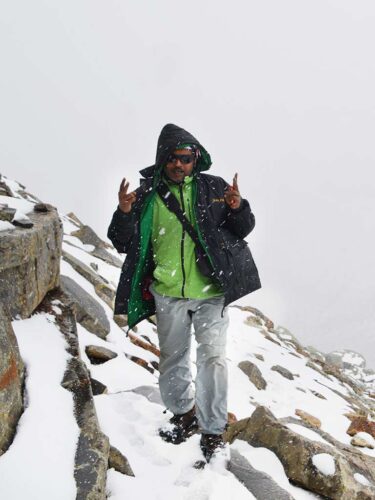Tourist enjoying snowfall on hampta Pass trek